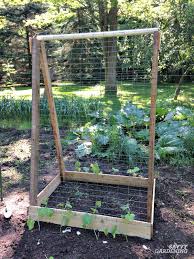 I hung the fencing so it would start all the way at the ground since the cucumber plants are not that big yet, and also produce fruit much closer to the plants roots then the squash do. Cucumber Trellis Ideas Tips Inspiration For Vegetable Gardens