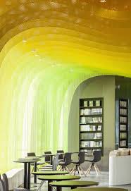 Bewitching Suzhou Bookstore Leaves Visitors In Awe With Its Undulating Ripples Of Candy Coloured Gradients Retail Interior Bookstore Ceiling Design