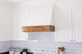 Stunning white cooktop designed with a white wood panel range hood, marble subway tiles and a wolf integrated gas cooktop. Diy Range Hood Cover Angela Marie Made