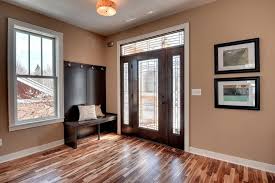 Trafficmaster laminate is good looking and the selection is decent. Balterio Laminate Flooring Reviews For Transitional Entry Also Baseboard Bench Built In Bench Seat Ceiling Light Cushions Framed Art Front Door Frosted Glass Glass Door Hardwood Floor Tan Wall White Window Trim