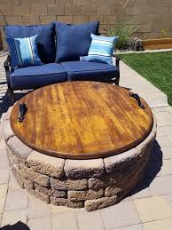 A Unique Way To Cover An Outdoor Fire Pit When Not In Use Just A Table Top Some Metal Handles And Stain Love How It Tur Fire Pit Table Patio Decor