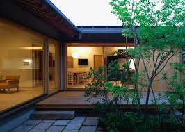 This includes tatami flooring, sliding doors, and wooden verandas circling the home. House Of Nagahama By Takashi Okuno Frames Five Courtyard Gardens