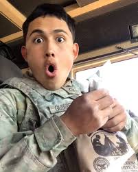 This soldier in the military shows off the food he receives in his ration  packs