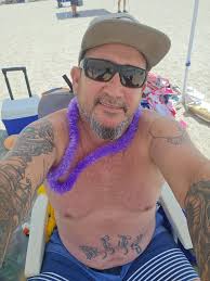 A woman from Rochester, New York, sits a top a car in West Palm Beach,  Florida, after traveling to attend an unnamed three-day rock festival in  1969. Photo by Robert H. Houston. |