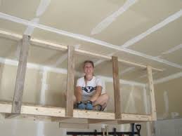 This contraption by delta uses a pulley system to efficiently lift and lower items. Overhead Storage Hanger Off 57