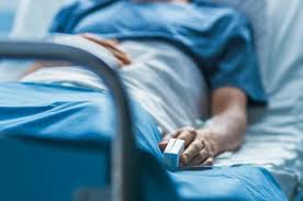 Male nurse or physician uses tablet computer, does checkup, woman recovering after successful surgery. Woman Dies In Hospital After Patient Attacks Her For Snoring