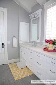 In this example, the gray bathroom's atmosphere is warmed up with a large plant and wood fittings. Girls Bathroom Decor The Sunny Side Up Blog Gray Bathroom Walls Light Grey Bathrooms Girl Bathroom Decor