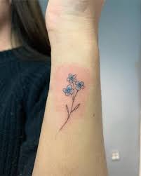 Sometimes, this plant can also grow in general, it has five charming, blue petals with the yellow center. Subtle Forget Me Not Flower Tattoo On The Wrist