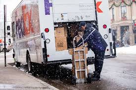 Unloading A Fedex Delivery Vehicle In The Snow Parcel Delivery Package Delivery Delivery
