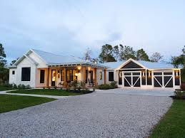 Black And White House Exterior One Story One Story Modern Farmhouse In Naples Florida White Exterior With Navy Blue Black Garage Modern Farmhouse Exterior House Exterior Blue Ranch House Exterior