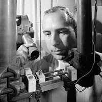 Helium-3 Activation Experiment. Thin aluminum foil containing one  ten-trillionth of an ounce of oxygen molecules is removed from target  holder by chemist, Samuel Markowitz, inventor of new trace analysis  technique. Photo taken
