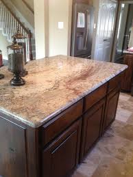 Typhoon bordeaux granite countertops combined with wood kitchen cabinets create a warm and welcoming atmosphere in the room. Typhoon Bordeaux Granite Countertop Options For Your Kitchen