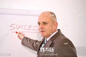 Manager Standing In Front Of A Flip Chart Labelled Success