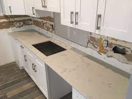 Carrara grigio quartz has a warm white background and soft gold clouds and veins that evoke a sensible chic design sure to garner attention. Quartz Countertops Installer Quartz Countertops Countertops Kitchen Cabinets And Countertops