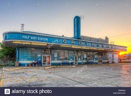 A Lone Passenger Waits For The First Bus At Sunrise At The Historic Greyhound Bus Station In Jackson Tennessee Stock Phot First Bus Greyhound Bus Bus Station