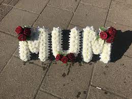The name chrysanthemum is derived from two greek words which translate to golden flower. Red And White Mum Funeral Flowers Tribute Wreath Funeral Flower Arrangements Funeral Flowers Flower Arrangements