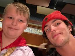 Pigskin pals: Stillwater high school senior and boy with autism bond over  football