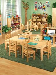 Warm And Inviting Colors On The Walls And Floor Windows Provide Natural Light Drawing And Coloring Materi Daycare Design Preschool Rooms Preschool Furniture