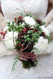A pretty christmas wedding bouquet of white blooms, berries, frostted berries and pinecones is a nice fit for a christmas bride. Creative Winter Christmas Wedding Bouquets Christmas Wedding Flowers Red Bouquet Wedding Winter Wedding Flowers