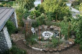 It's more natural than rustic, kind of a shabby chic look, and you can dress it up or down with furniture and fire pit seating ideas. Fire Pit Inside A Keyhole Garden Keyhole Garden Front Yard Garden Unique Gardens