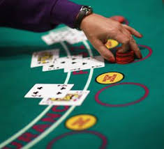 The dealer deals one card face up to each player, from left to right, with the last card going to the house's hand, which is face down. Wjnmcys Bi Sim