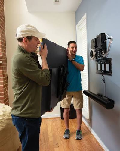 Professional technician installing and mounting flat screen television on wall in Chislehurst BR7