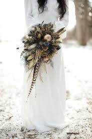 When we saw this texture filled bouquet, the anemones immediately caught our eye. Photo Fridays Winter Bohemian Bridal Inspiration Feather Bouquet Wedding Feather Bouquet Feather Wedding