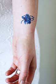 Another flower tattoo on the belly. Small Delft Blue Flower Tattoo Blue Flower Tattoos Blue Ink Tattoos Blue Tattoo