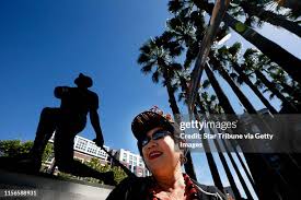 Giants fan Sam Sakai-Miller sat near the statue of Willie Mays Sunday...  News Photo