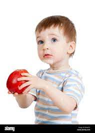 Baby Boy Holding And Eating Red Apple Isolated On White Stock Photo Alamy