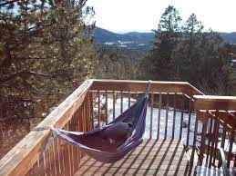 Here's exactly how to hang a hammock safely, plus all the ins and outs you'll need to know. Hammock Hanging From Deck Rails Using Straps Backyard Paradise Deck Railings Outdoor Space