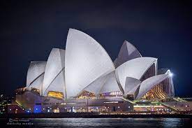 White Night The Sydney Opera House In A Blaze Of Light Against The Night Sky As Seen From The Rocks On The Shores Of Sy Sydney Opera House Night Sightseeing