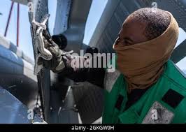 Aviation Machinist's Mate Third Class (AD3) Laura Johnson adds the last  minute touches of safety wire and inspects the linkage assembly for a T-58  engine before it is shipped out to a