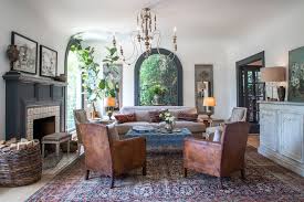So Many Details Deep Teel Woodwork And Tufted Ottoman Warm Rug And Leather Chairs Wicker Basket Of Wood Logs Chande Home Transitional Living Rooms Interior