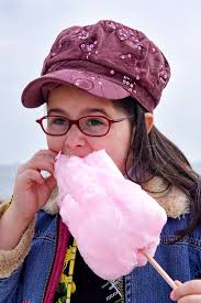 Close Up of Young Girl Eating Cotton Candy Stock Photo