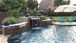 With the solid pool surround and just enough flowers to add some color, this backyard pool respects the classic feel of the home. Transitional Curved Cool Pool With Amazing Water Features Fly By Youtube