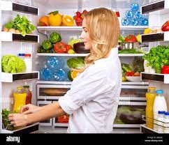 Happy Female Search Something In The Fridge Fresh Fruits And Vegetables In The Refrigerator Cooking Diet Food Fit And Body Care Concept Stock Photo Alamy