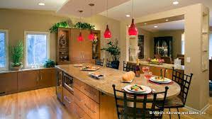 Large Kitchen Island With Cherry Cabinets Granite Countertop And Red Pendant Lights Hanging From A Large Kitchen Kitchen Pendants Large Kitchen Pendant Light