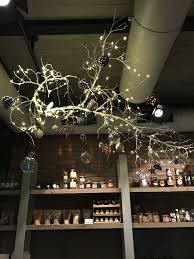 Large Branch Hanging From The Ceiling With Minimal Decorations Branch Decor Interior Design Your Home Green Wall Art
