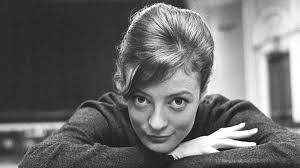 a black and white photo of a woman sitting at a table