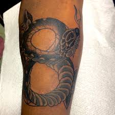 This tattoo represents his love for singing and his uncle felix, who raised him like a father and got him into music by gifting him his first mic at the. Tattoo Uploaded By Speak Proper Black Mamba Figure 8 1448009 Tattoodo