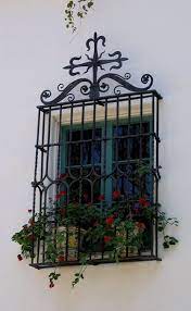Burglar bars are mostly metal, though they may have some plastic sections. Window Boxes Window Gardens Garden At The Window Iron Window Wrought Iron Window Spanish Style Decor