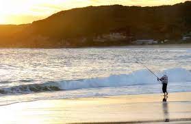 A Person Fishing On The Beach And Sunrise Photo John Yurasek National Parks Best Campgrounds Camping Places