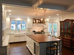 Taylor made custom cabinetry & design. Historic Kitchen With Carrara Marble Perimeter Countertops And A Butcher Block Island White Kitchen Rustic Classic White Kitchen White Tile Kitchen Backsplash