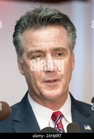 New Virginia head football coach and longtime Clemson assistant coach Tony  Elliott, right, his wife Tamika Elliott, left, and sons, A.J., front left,  and Ace, front right, pose for pictures prior to