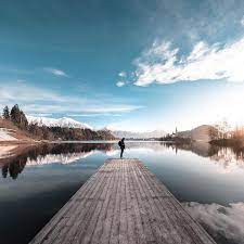 Photo Of The Day Like A Sheet Of Glass Sheck Braved A Brisk Morning To Catch The Sunrise Over Lake Bled In S Travel Life Lake Bled Landscape Photography