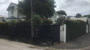 Gate partly walled in by fence