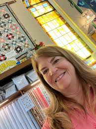 Quilt shop with pretty windows and fabric