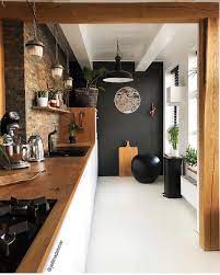 Unique feature wall ideas including moulding walls, wallpaper, paint, sharpies, and more! Black Accent Wall In The Kitchen Stone White Natural Wood Home Decor Kitchen House Interior Home Decor