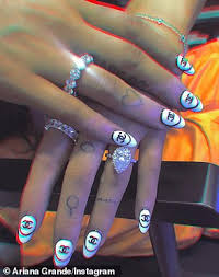 Poor ariana grande proudly tweeted out her painful hand tattoo that was designed to read 7 rings in japanese, but quickly discovered thanks to twittter that it instead read shichirin (small japanese grill). Ariana Grande Shows Off A Selection Of Her 48 Tattoos As She Flashes Arm Inkings In Sultry Selfie Daily Mail Online